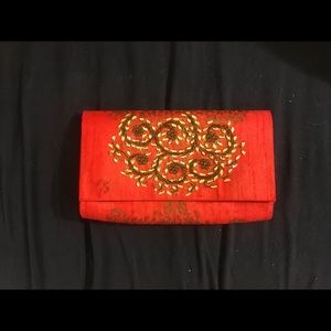 Fabindia: orange silk embroidered clutch